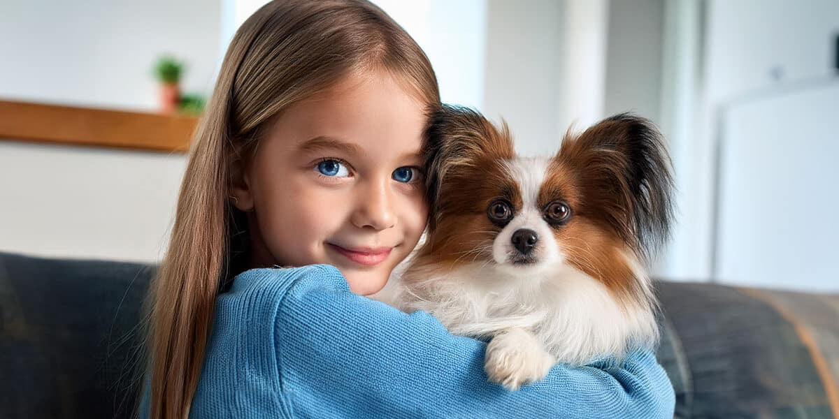 Girl holding papillon