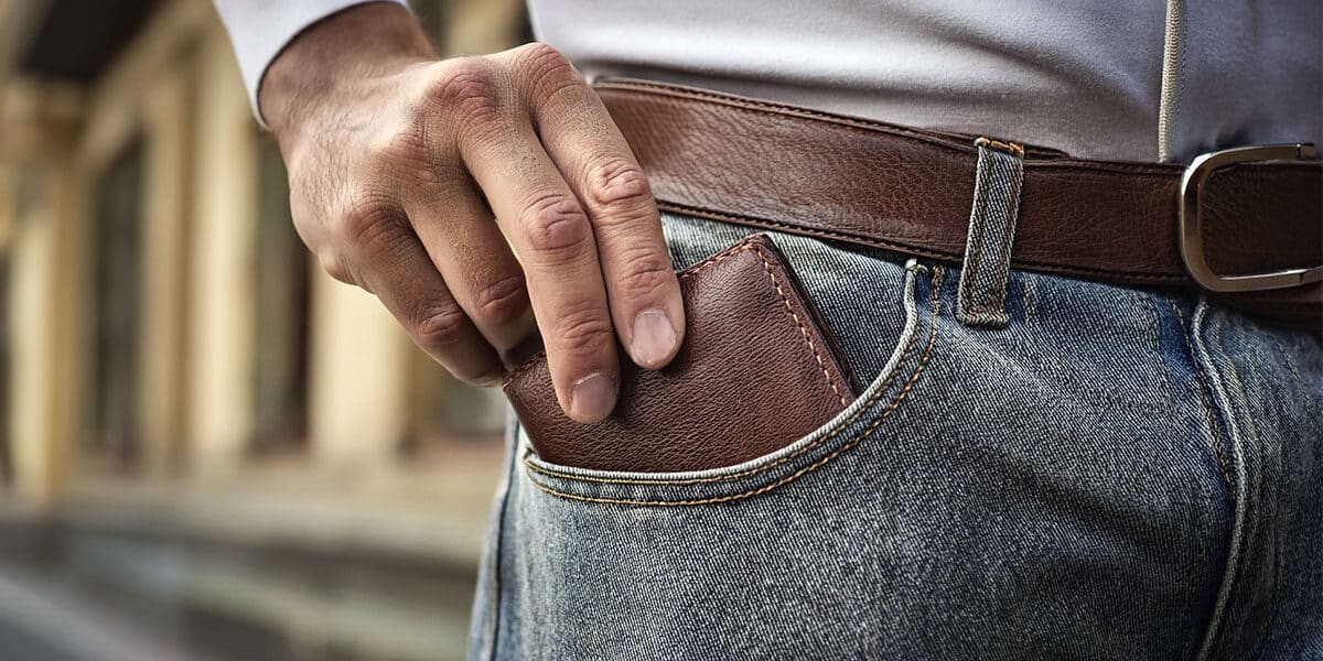 Man reaching into pocket for wallet