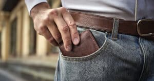 Man reaching into pocket for wallet